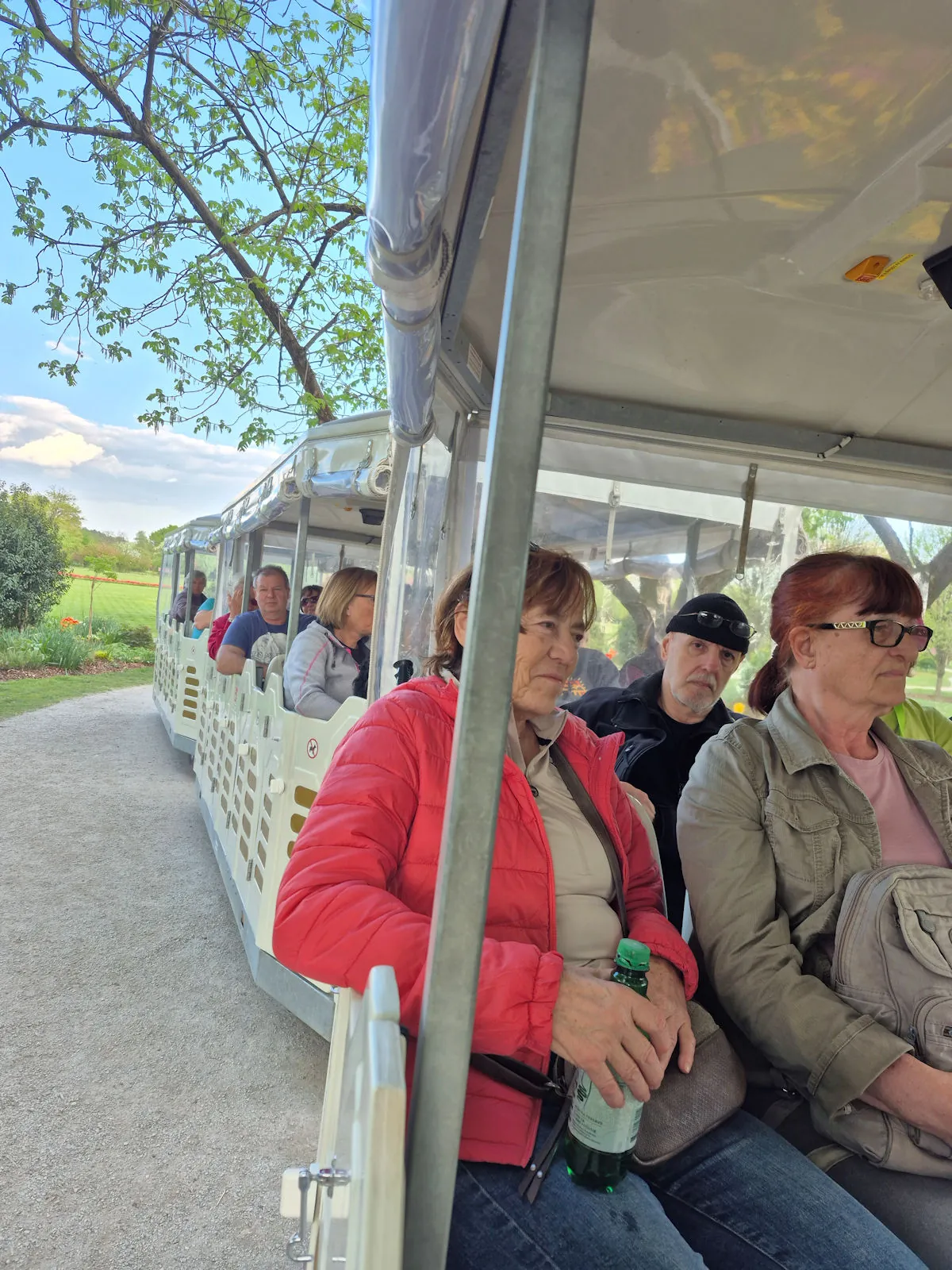 Club members sit in the train carriages during their ride through the Arboretum